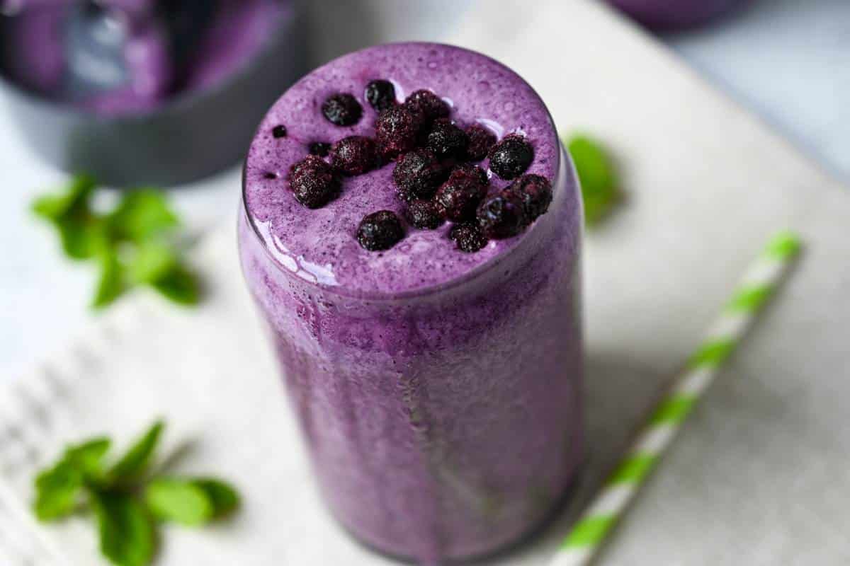 side view of a wild blueberry protein shake