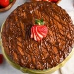 a brownie tart on a cake stand