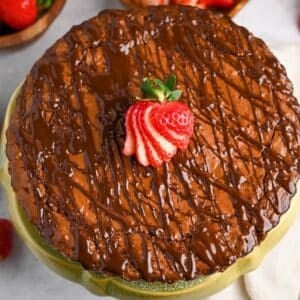 a brownie tart on a cake stand