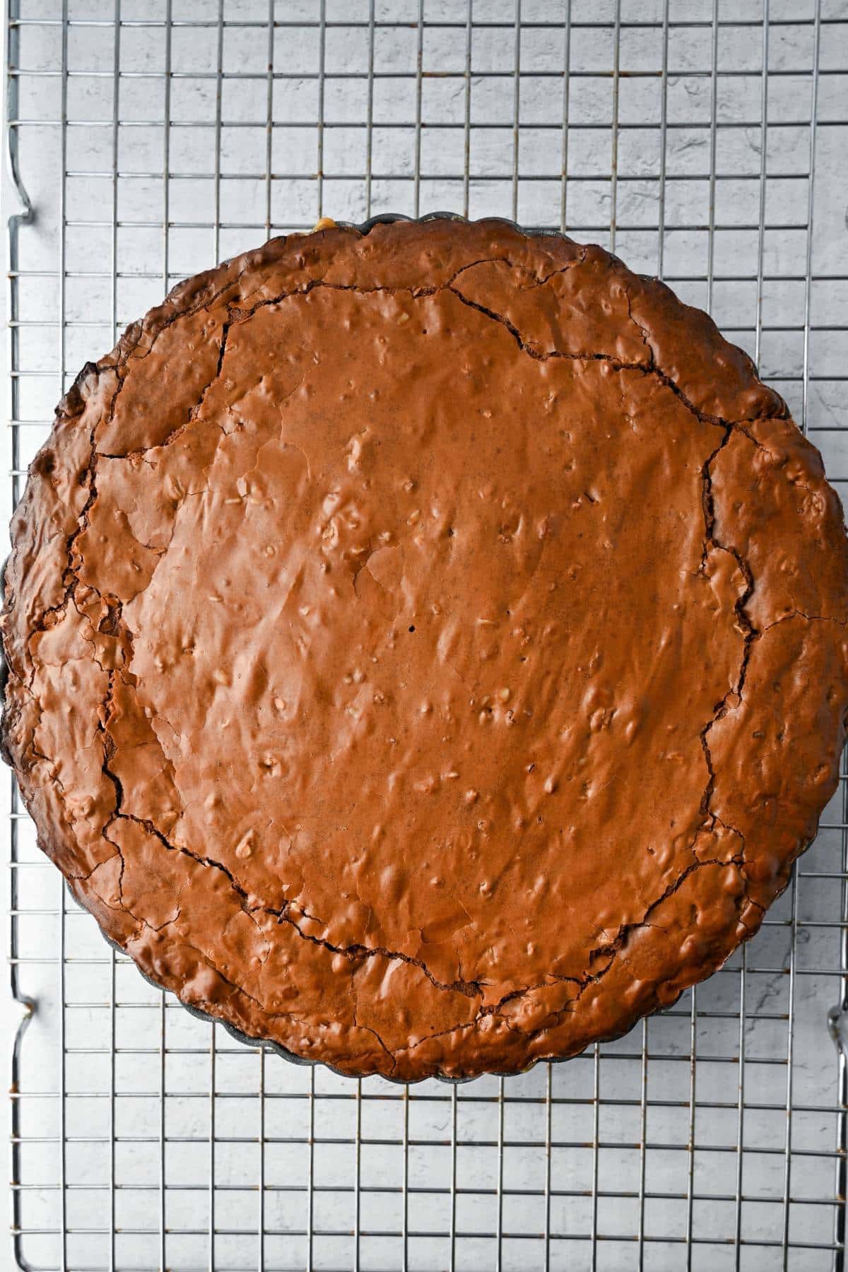 baked brownie tart on a cooling rack