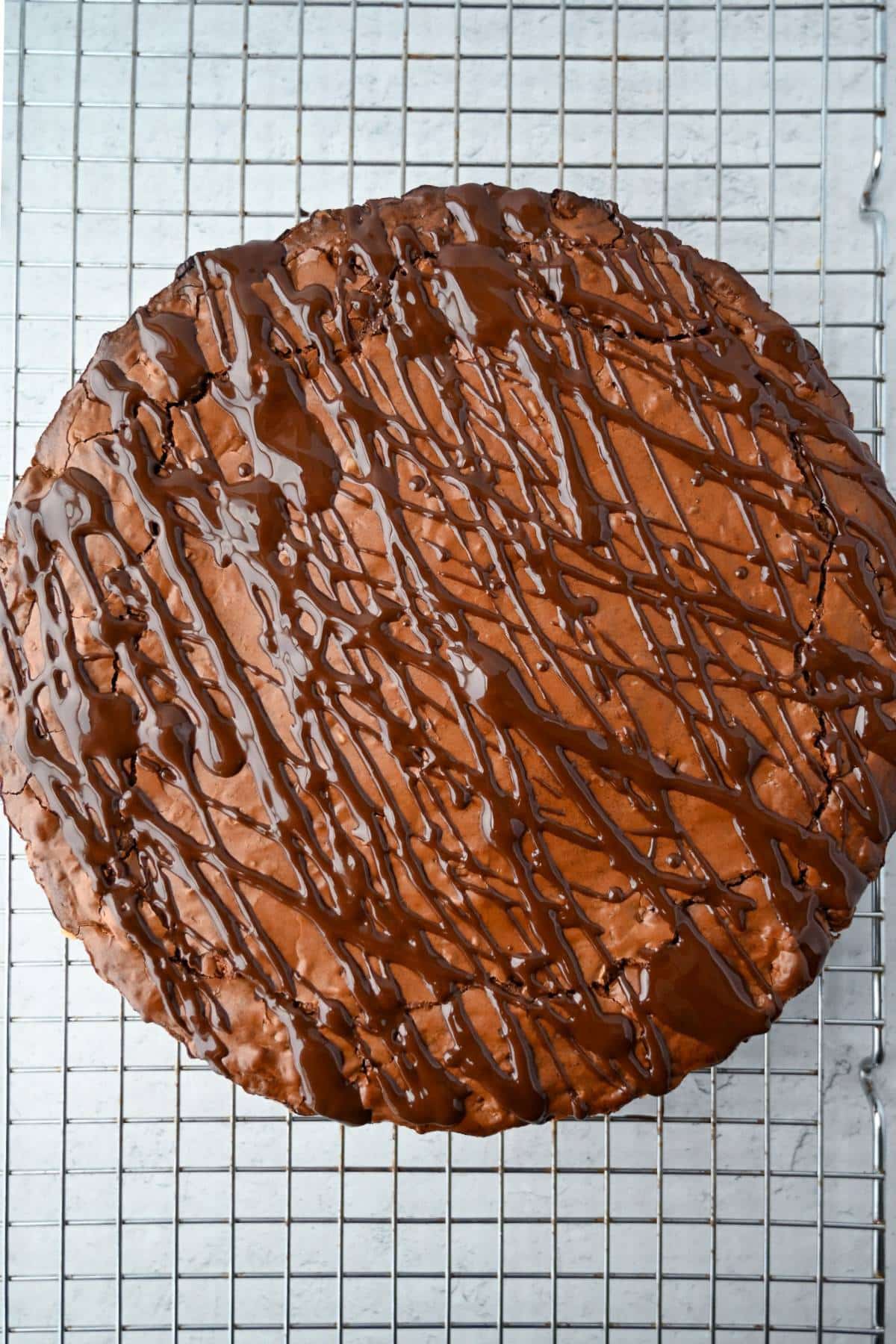 baked brownie tart with chocolate drizzle on top