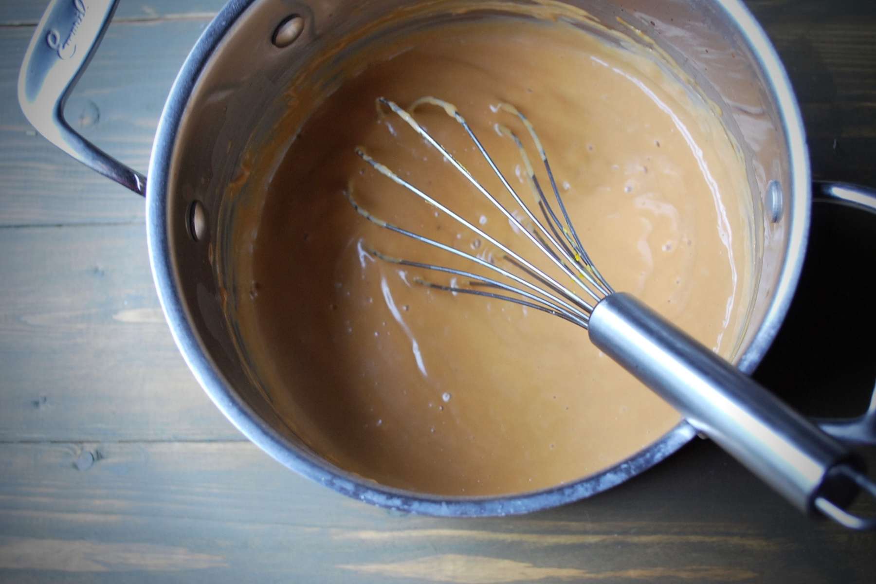 pudding in a saucepan with a whisk