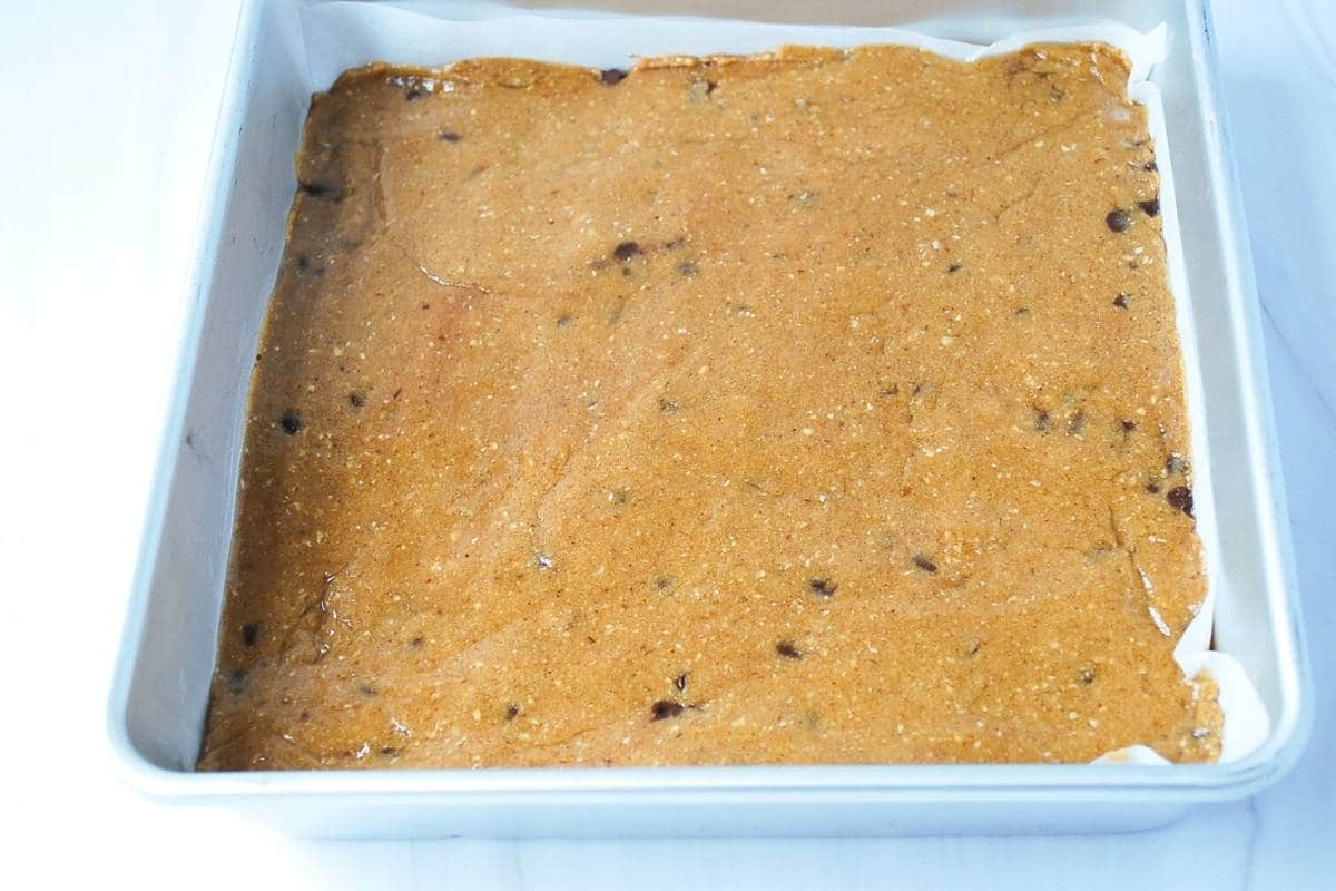 gluten-free protein bar batter in a pan ready to chill