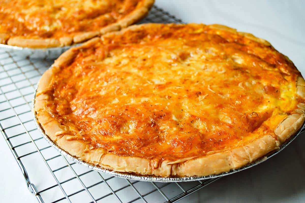 2 baked quiches cooling on a rack