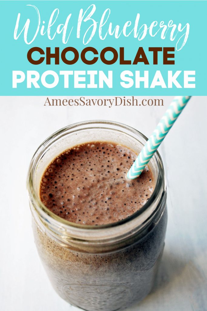 blueberry chocolate protein shake in a glass with straw with text description for Pinterest