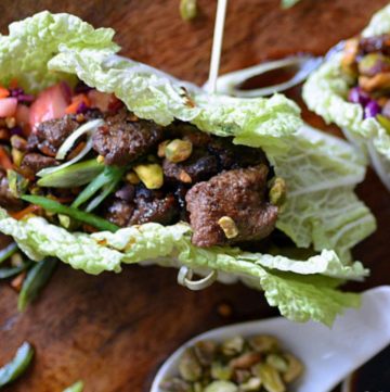 beef lettuce wraps with a spoon of sauce next to it