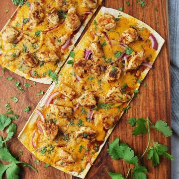 BBQ chicken flatbreads on a cutting board with cilantro