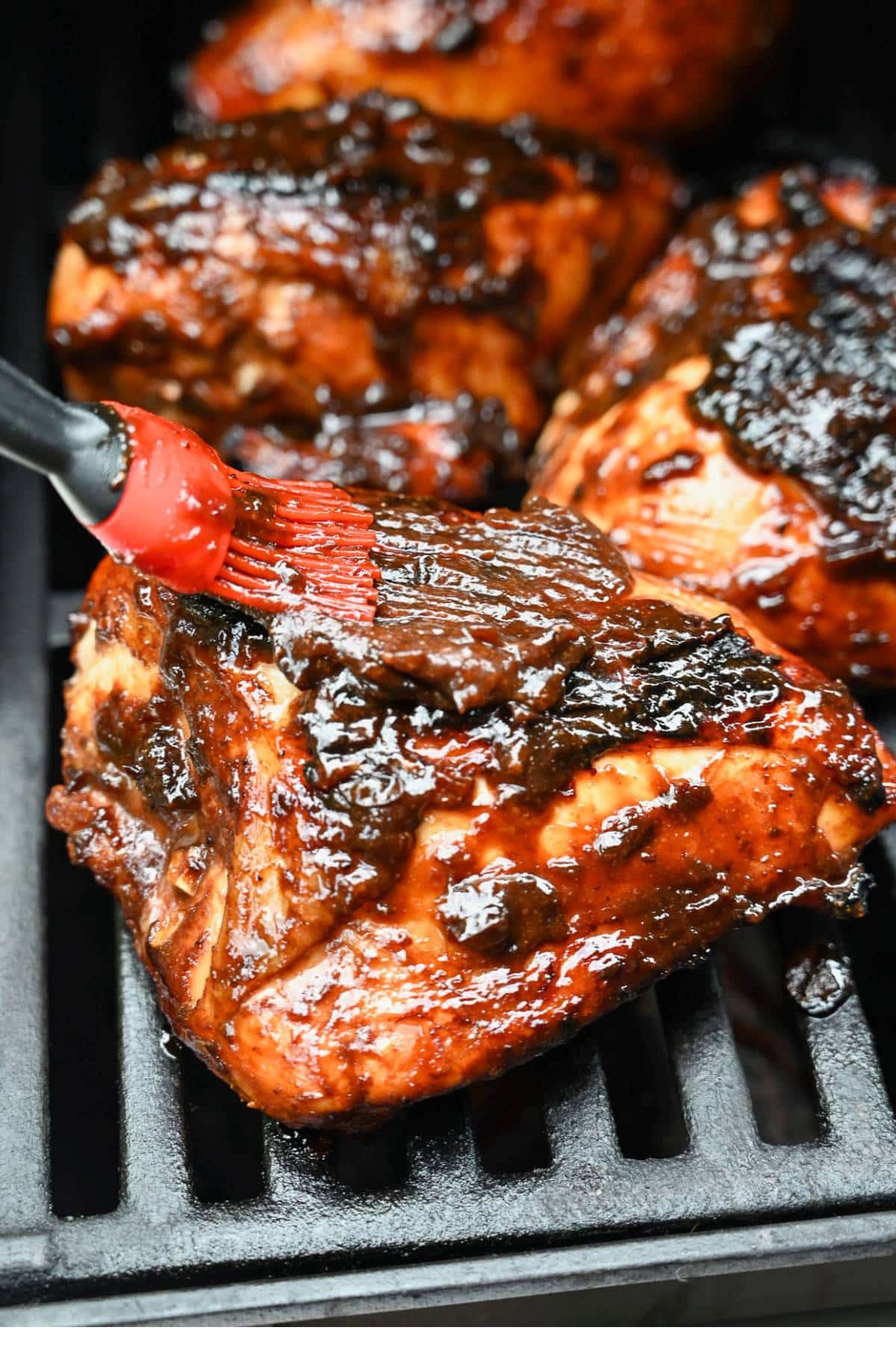 bone in chicken basted with a bbq plum sauce on the grill