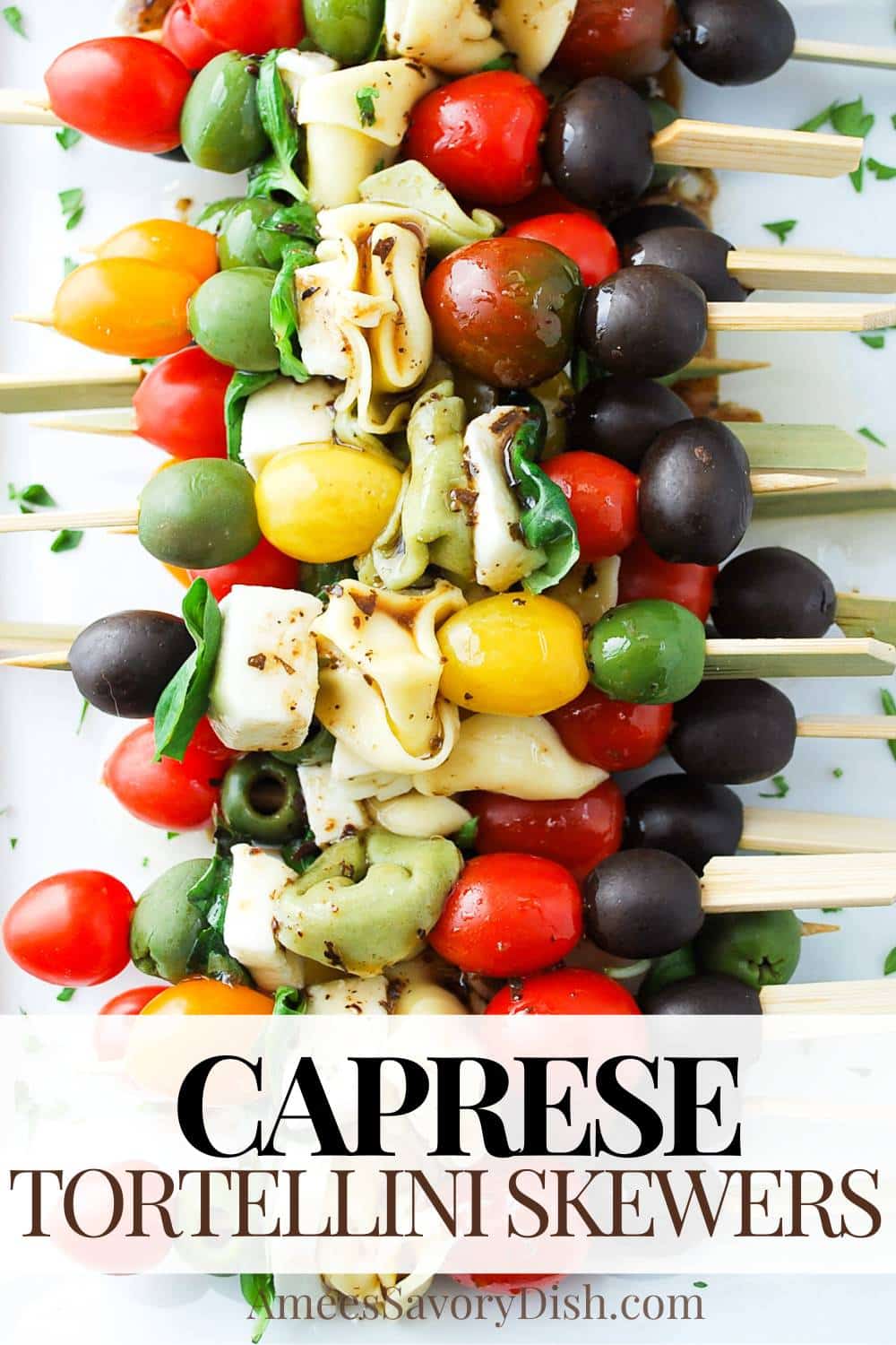 Caprese Tortellini Skewers showcases fresh basil, tomatoes, mozzarella cheese, olives, & cheese tortellini drizzled with balsamic dressing. via @Ameessavorydish