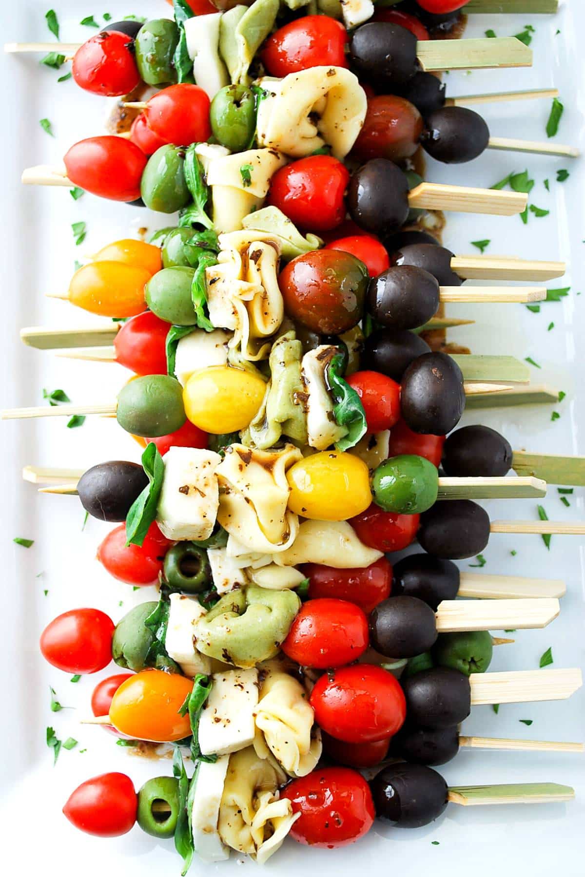 overhead shot of a platter of caprese appetizer skewers