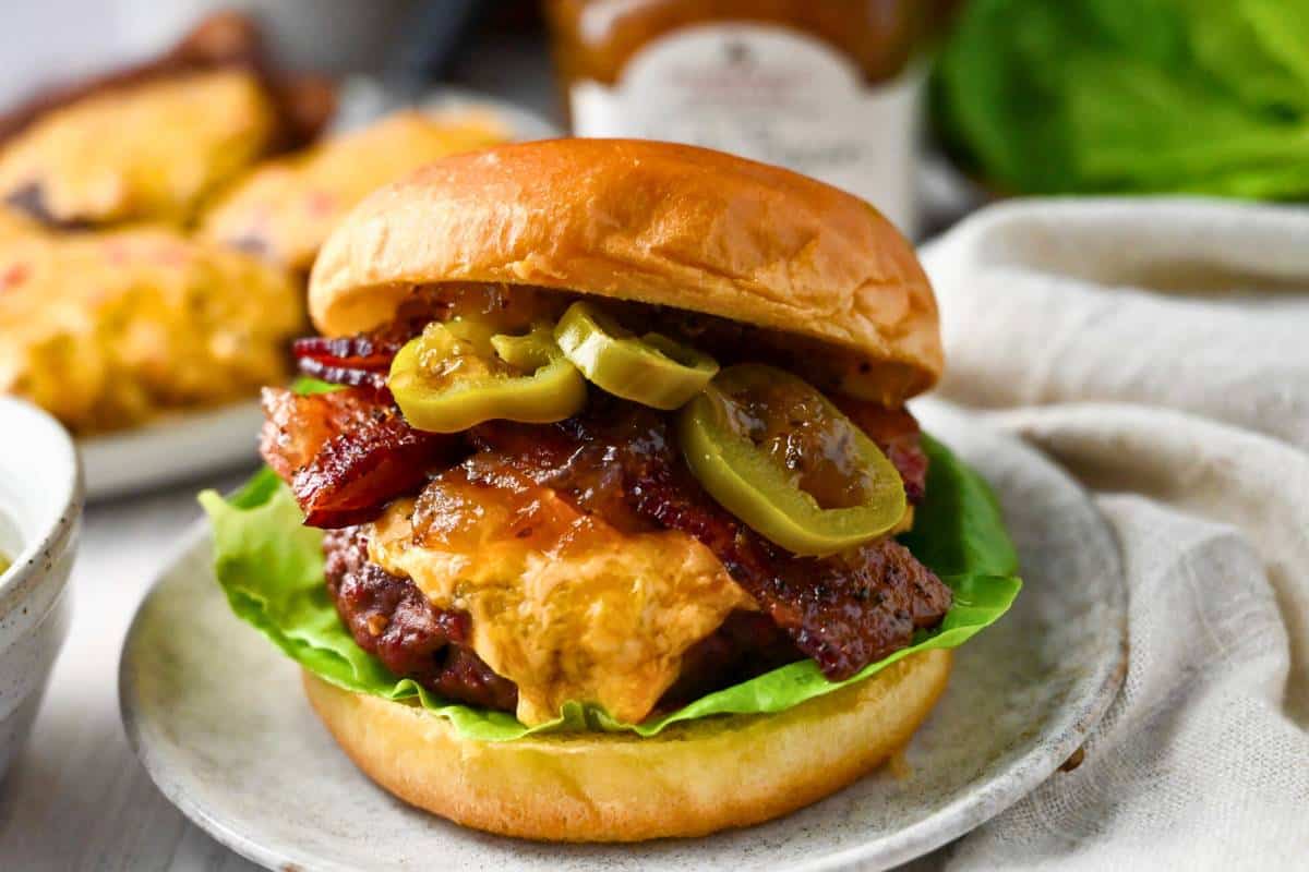 close up of a loaded burger with pimento cheese and bacon
