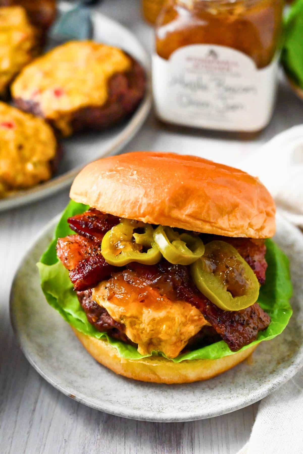 Fire up the grill for Pimento Cheese Burgers featuring juicy ground sirloin patties topped with jalapeño pimento cheese. These epic burgers are guaranteed to steal the show at your next cookout! via @Ameessavorydish
