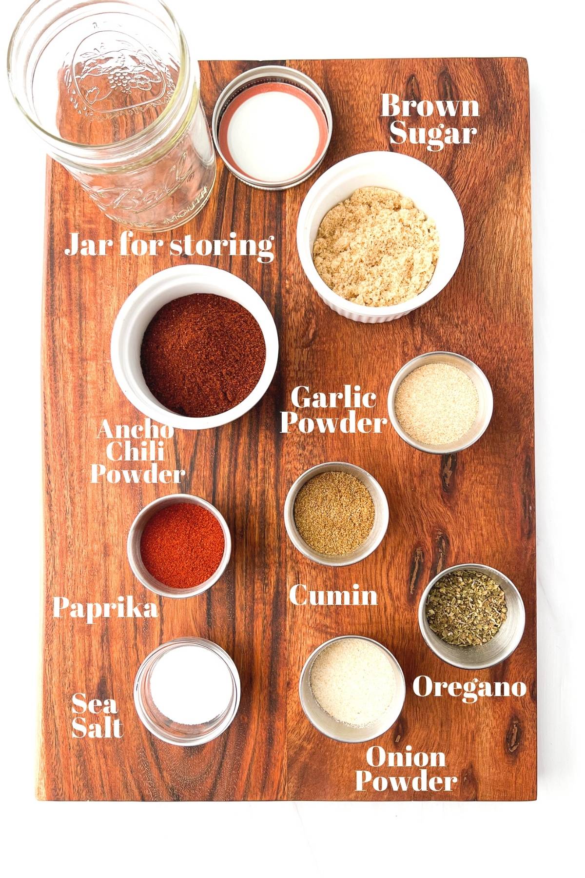 measured out ingredients for homemade taco seasoning on a wooden board