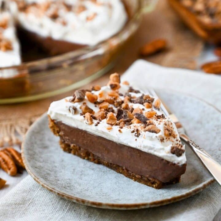 a slice of chocolate cream pie with toffee bits on top