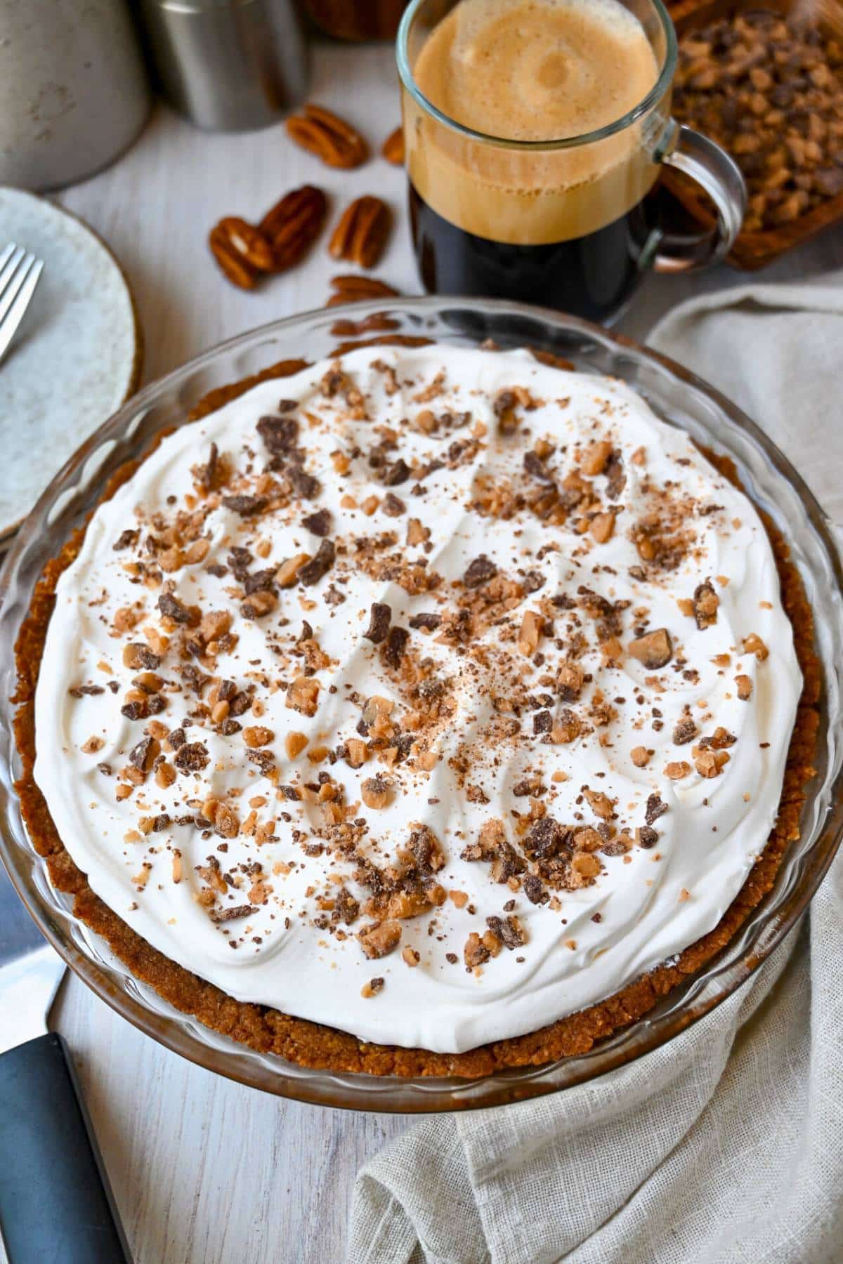 close up of a whole chocolate cream pie with toffee bits