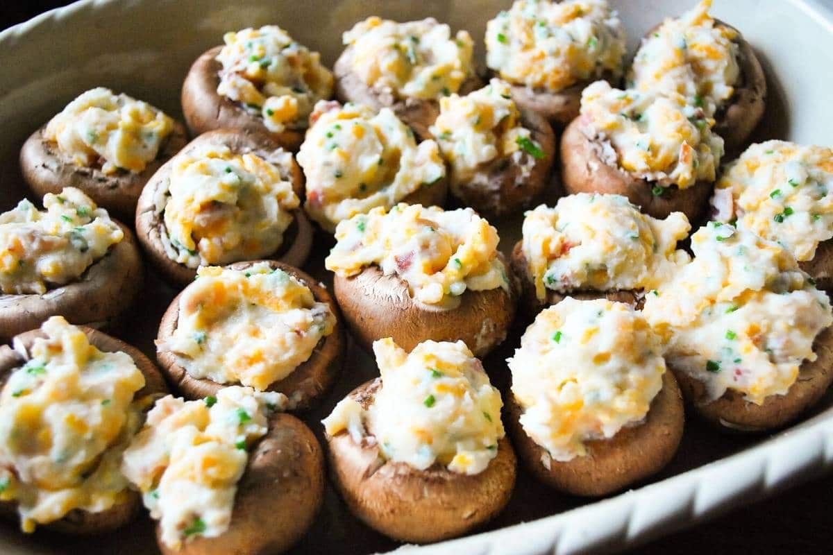 baby bella mushrooms stuffed with loaded potato filling in a baking dish