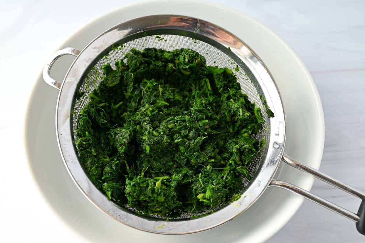 spinach draining in a colander