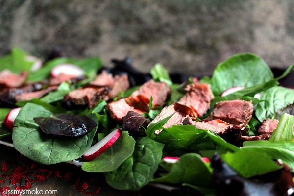 Steak salad on a dark plate