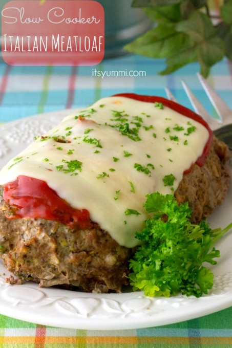 Meatloaf on a plate covered with sauce and cheese