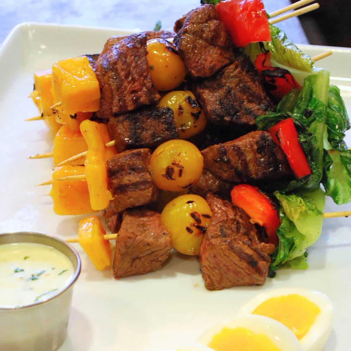 steak kebabs with grilled romaine and ranch vinaigrette