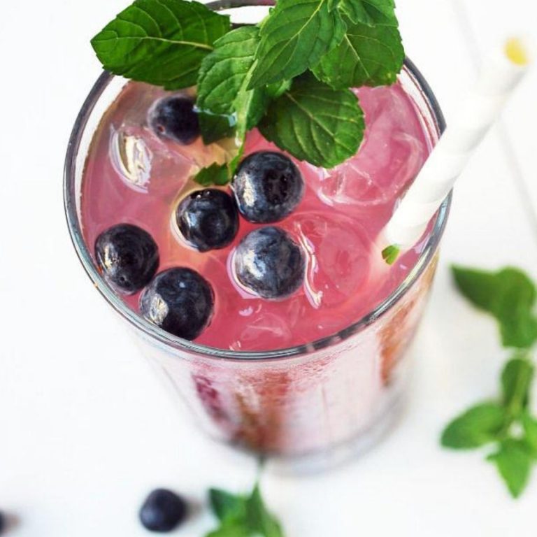 Blueberry Mojito with lavender garnished with mint and a straw