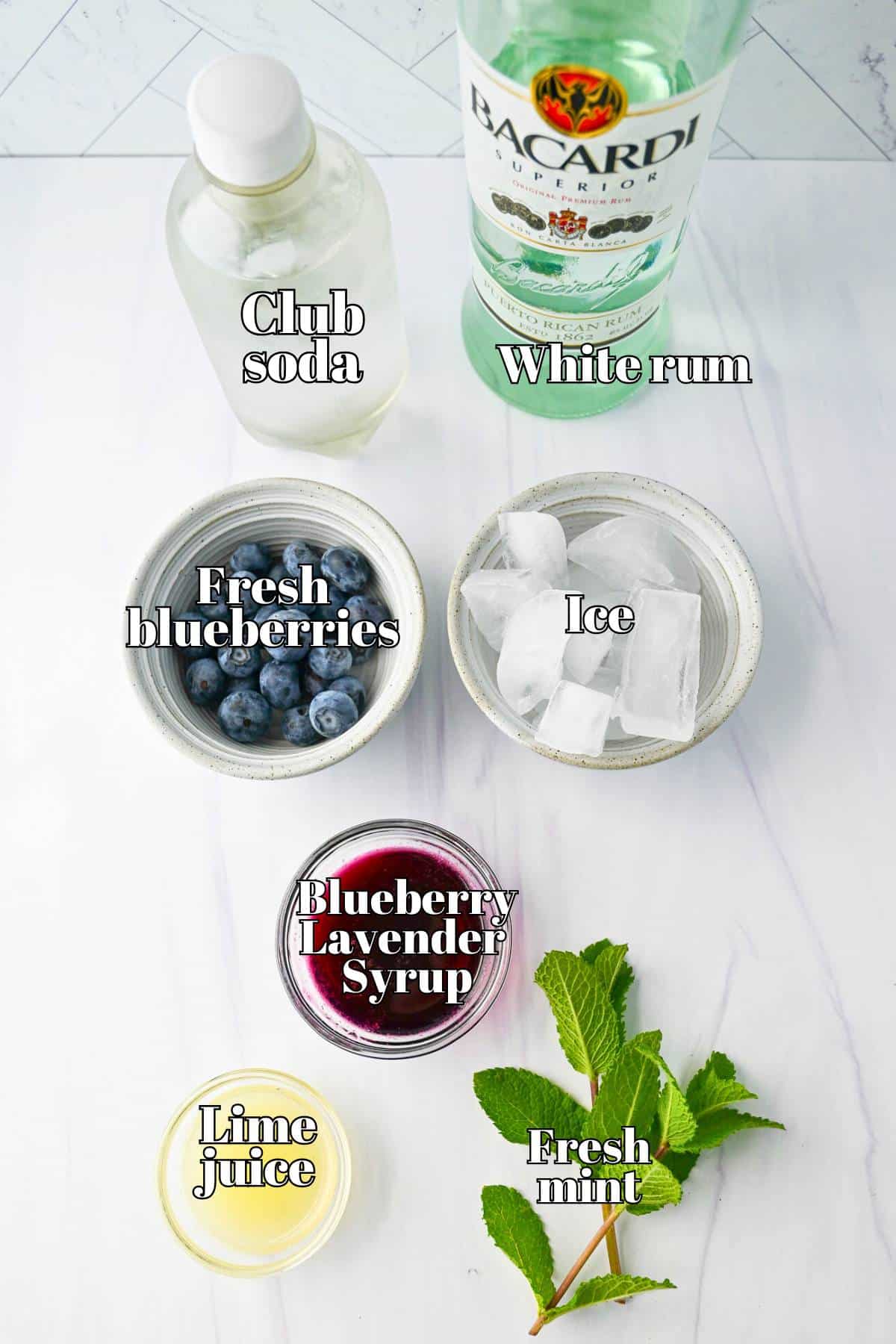ingredients for blueberry lavender mojitos measured out on a counter