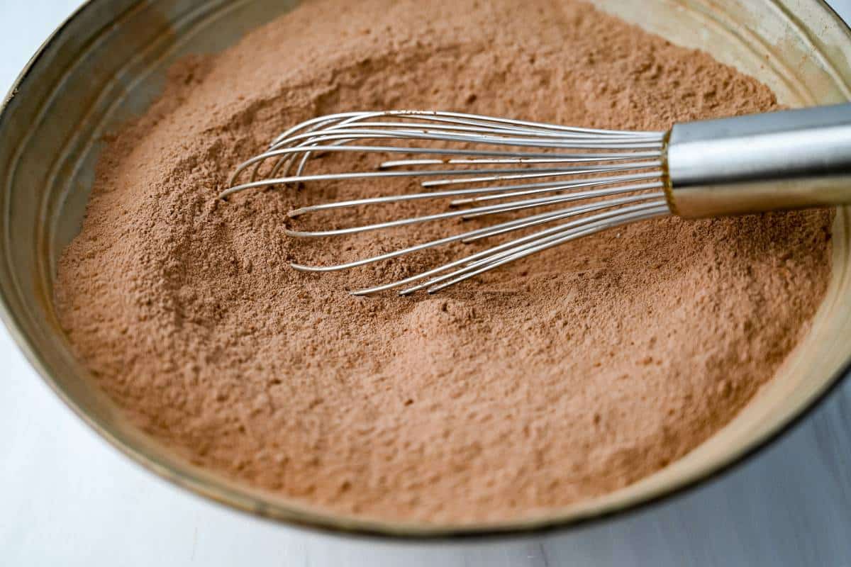 dry ingredients for chocolate cupcakes whisked in a bowl