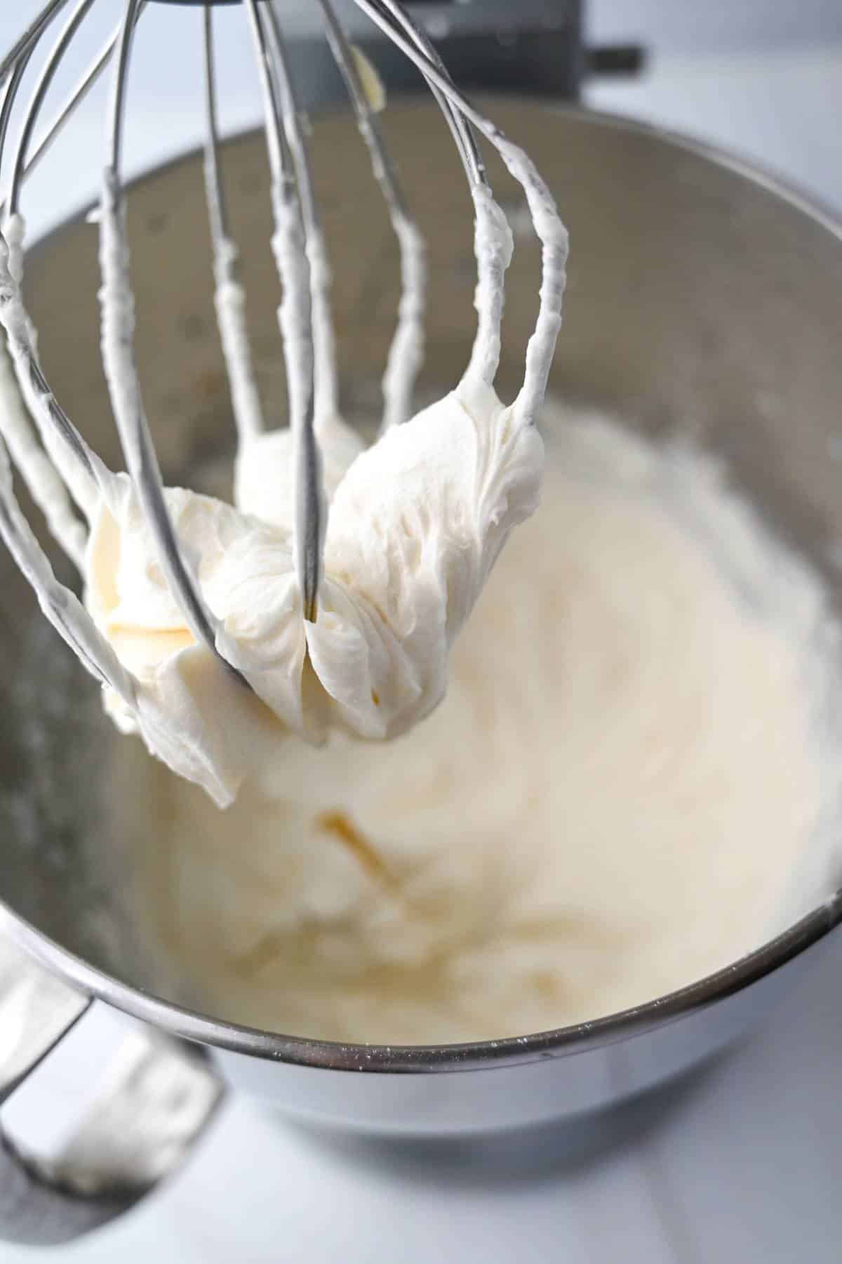 vanilla buttercream in a mixing bowl with whisk attachment