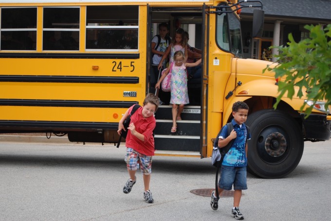 Kids getting off a school bus