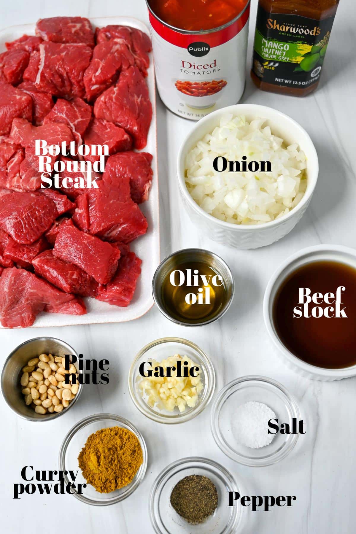 ingredients to make mango beef curry measured out on a counter