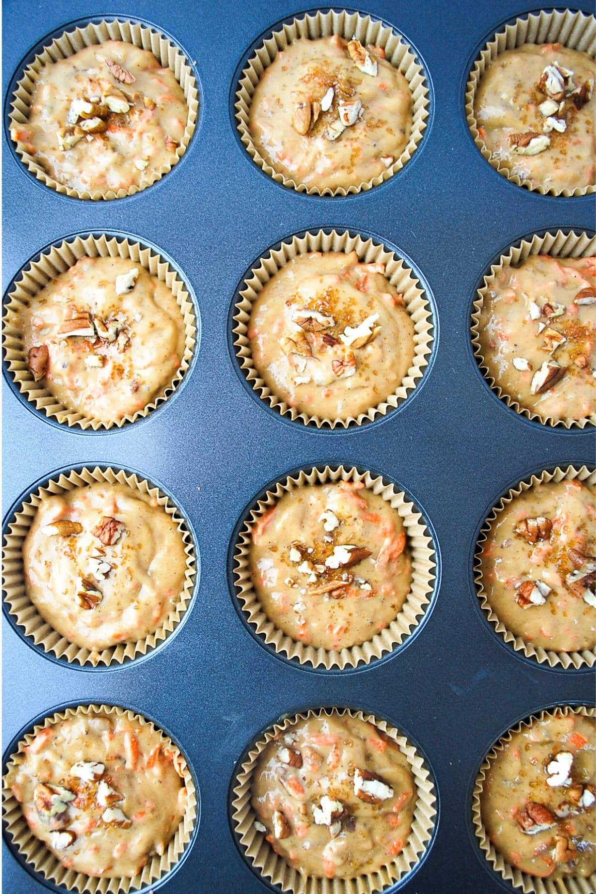 banana carrot muffin batter in lined cupcake tins