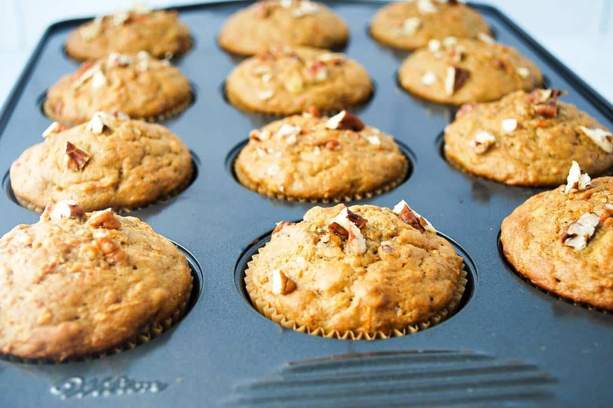 banana carrot muffins fresh from the oven in a muffin pan