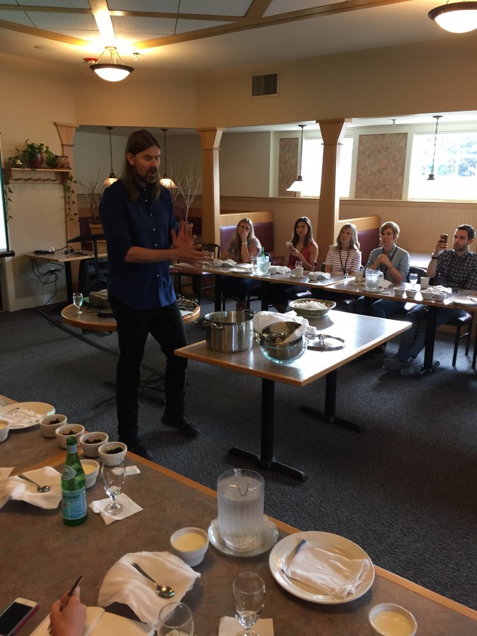 A group of people standing around a table in a room