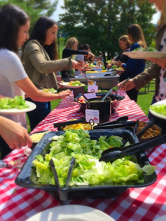 A group of people around a large buffet table