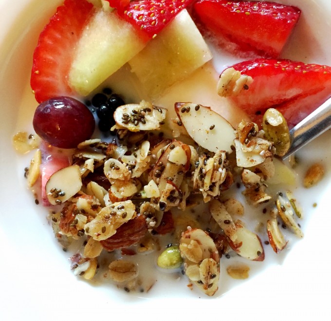 Skillet granola in a bowl with fruit and milk