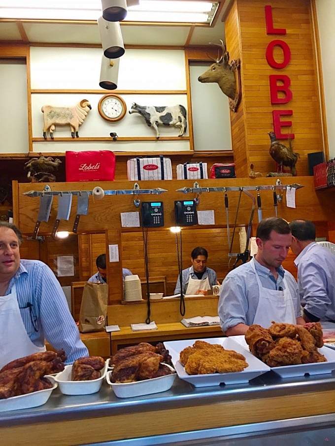 Employees behind the counter at Lobels butcher shop in NYC