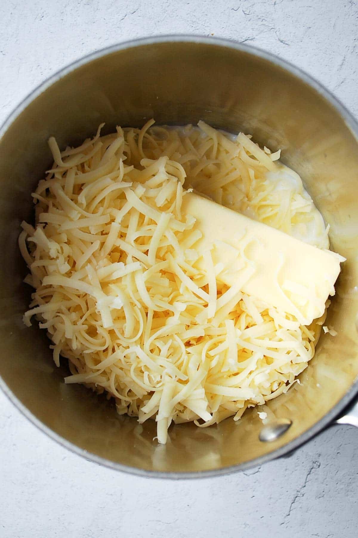 butter, cheese, and milk in a sauce pan