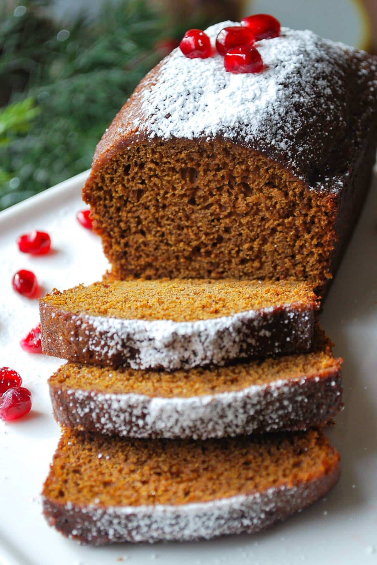 close up of a soft gingerbread loaf with powdered sugar topping