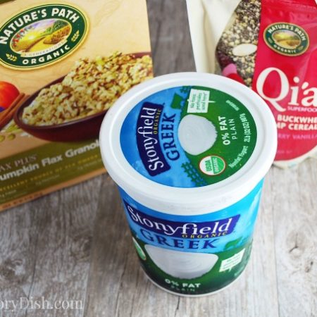 Tub of yogurt with cereals in the background