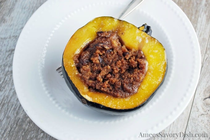 Stuffed acorn squash in a bowl with a fork