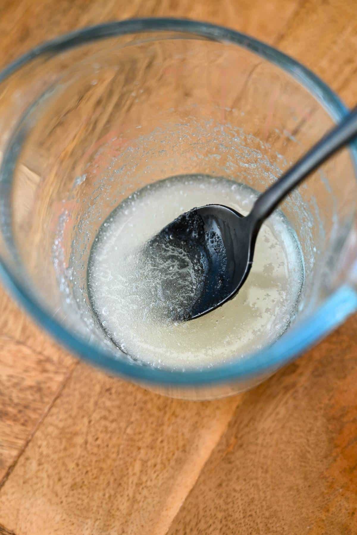 gelatin in a pyrex container with a spoon