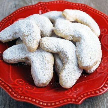 powdered sugar cookies on a red plate