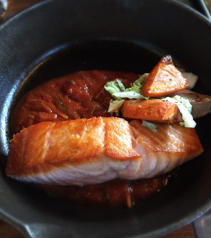 braised salmon in a cast iron skillet
