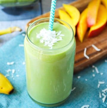 close up of an island green smoothie with banana and sliced mango