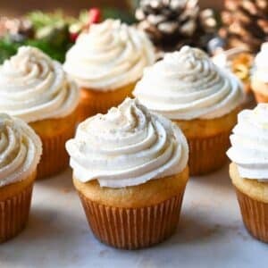 eggnog cupcakes on a platter dusted with nutmeg