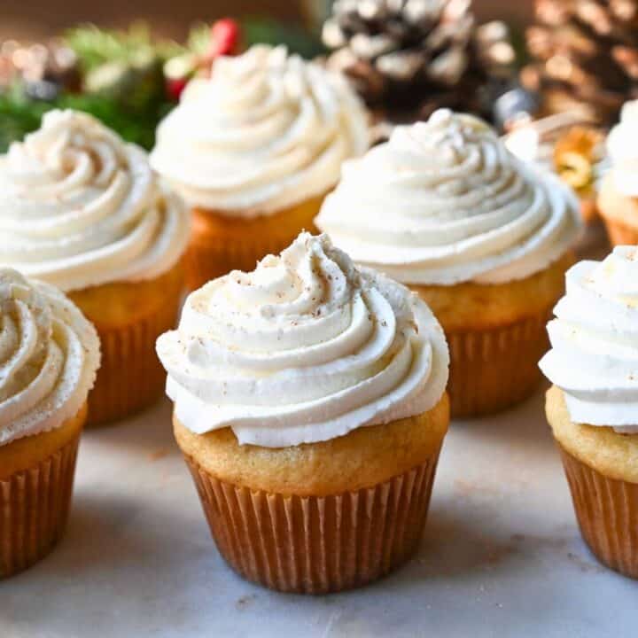 eggnog cupcakes on a platter dusted with nutmeg