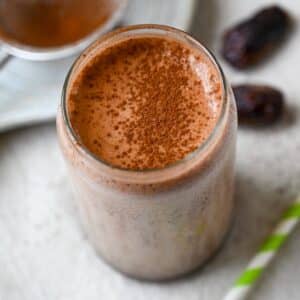a chocolate shake dusted with cocoa powder on top