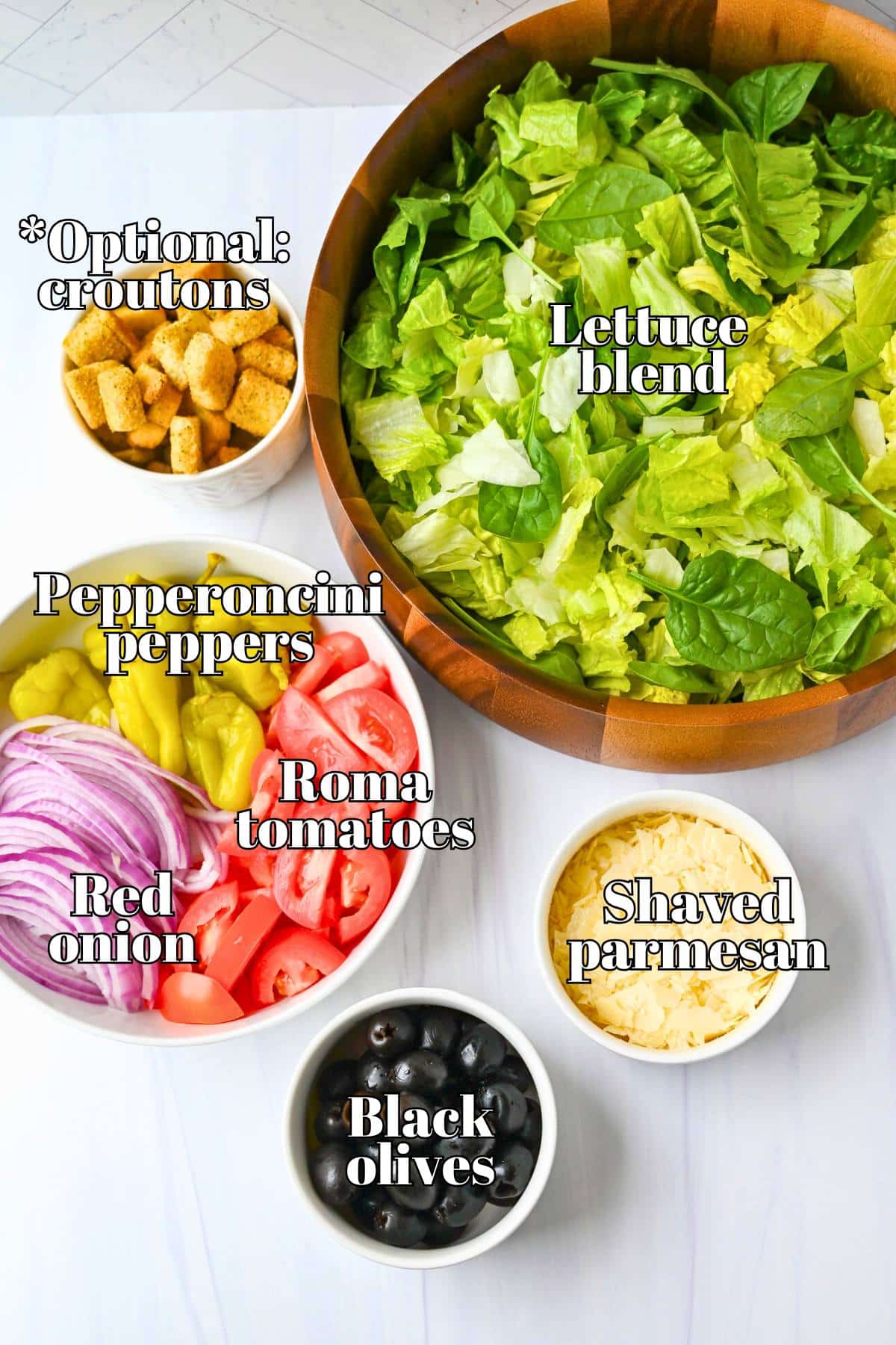 ingredients for making olive garden salad at home measured out on a counter