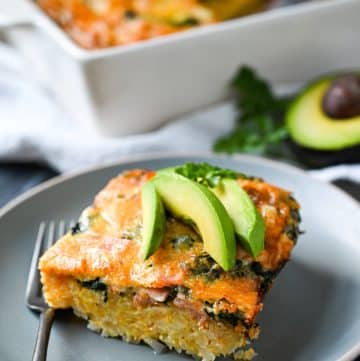 a slice of hashbrown casserole topped with fresh avocado slices