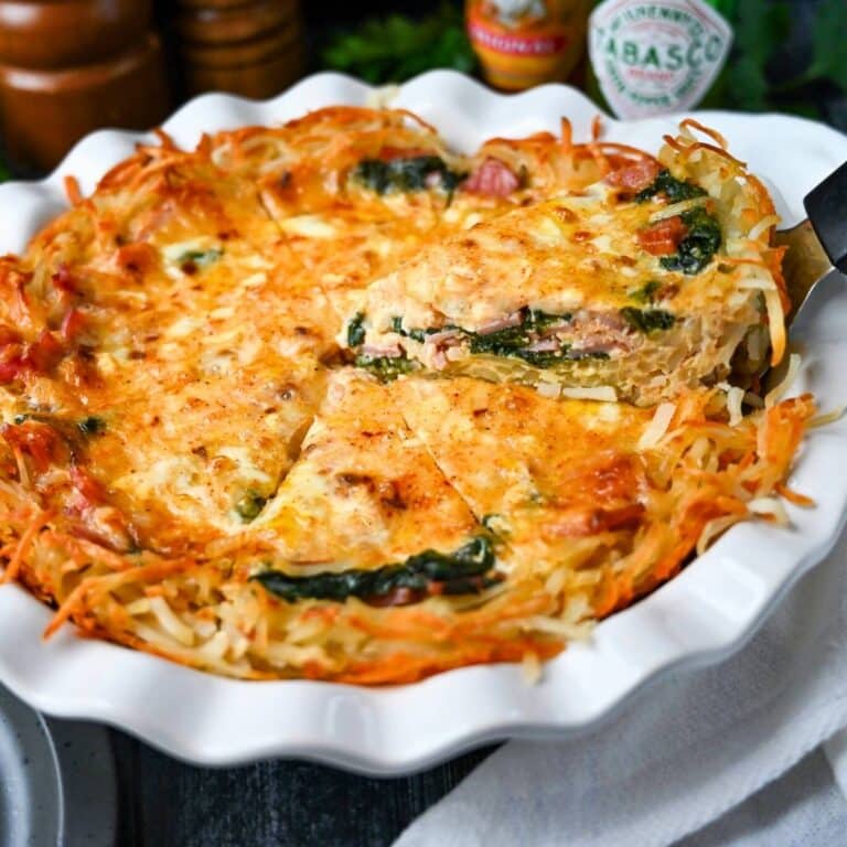 close up of a sliced hash brown crush quiche